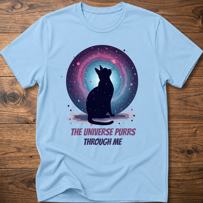 Light blue cat t-shirt with cosmic cat silhouette and purple "The universe purrs through me" text