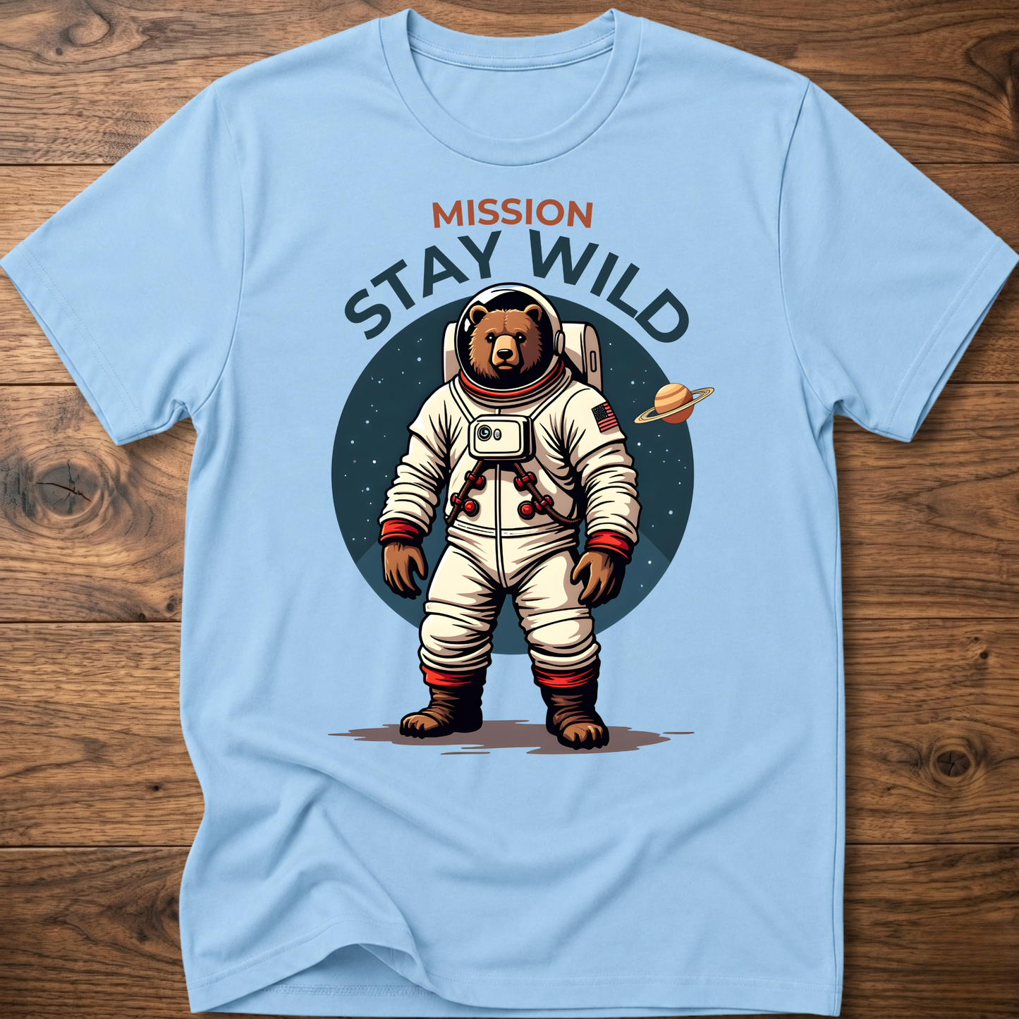 Light blue crew-neck T-shirt with 'Mission Stay Wild' astronaut bear graphic