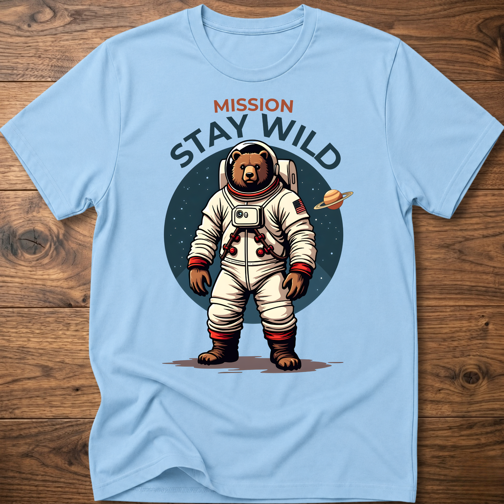 Light blue crew-neck T-shirt with 'Mission Stay Wild' astronaut bear graphic