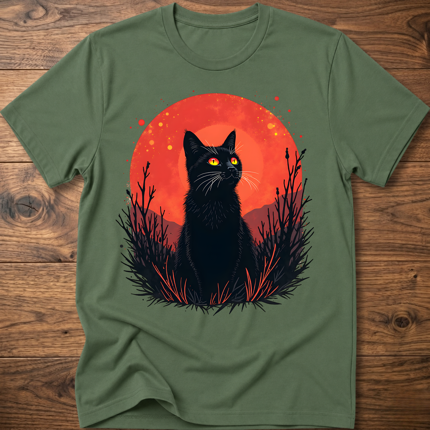 Olive green T-shirt with black cat graphic in red-orange halo and night-plant silhouettes