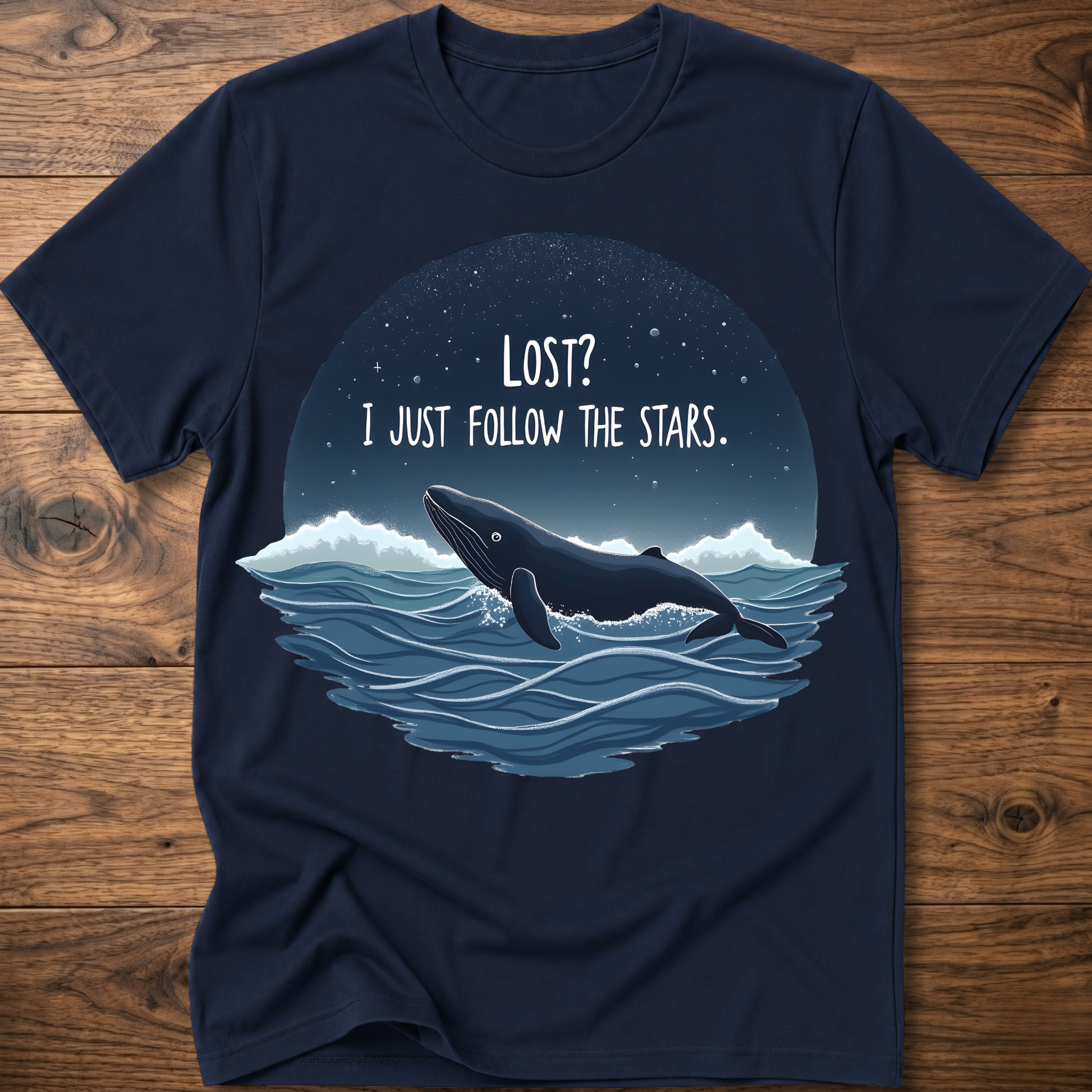 Navy whale graphic t-shirt with circular “LOST? I JUST FOLLOW THE STARS.” print