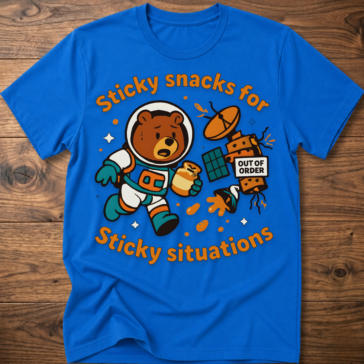 Royal blue bear graphic t-shirt with cartoon snack scene and 'Out of Order' badge