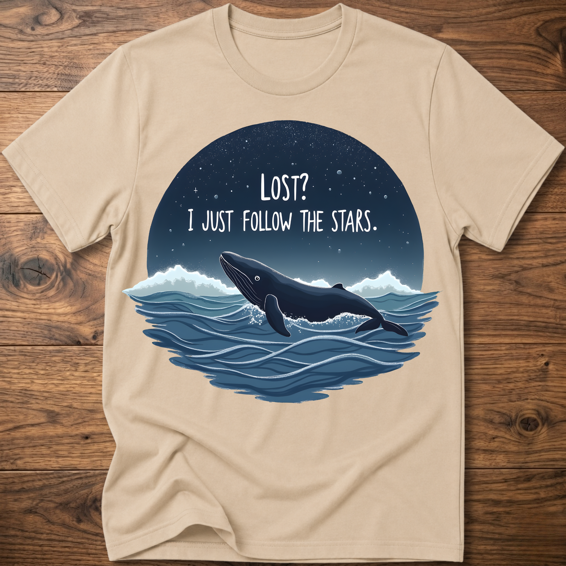 Sand whale graphic t-shirt with circular “LOST? I JUST FOLLOW THE STARS.” print