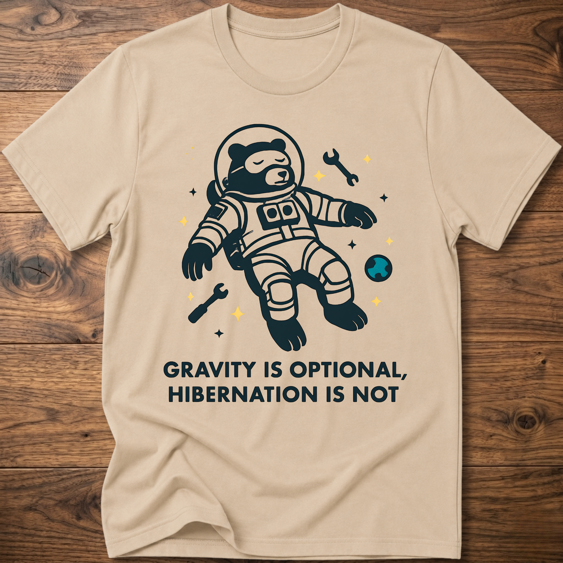 Hibernation bear astronaut t-shirt in sand with front astronaut bear graphic and slogan text