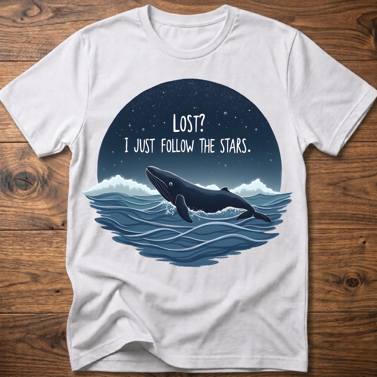 White whale graphic t-shirt with circular “LOST? I JUST FOLLOW THE STARS.” print